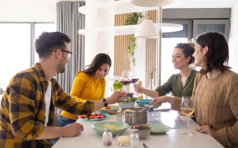 friends eating at a colourful, long dining table, food scene, August 2024, Australia